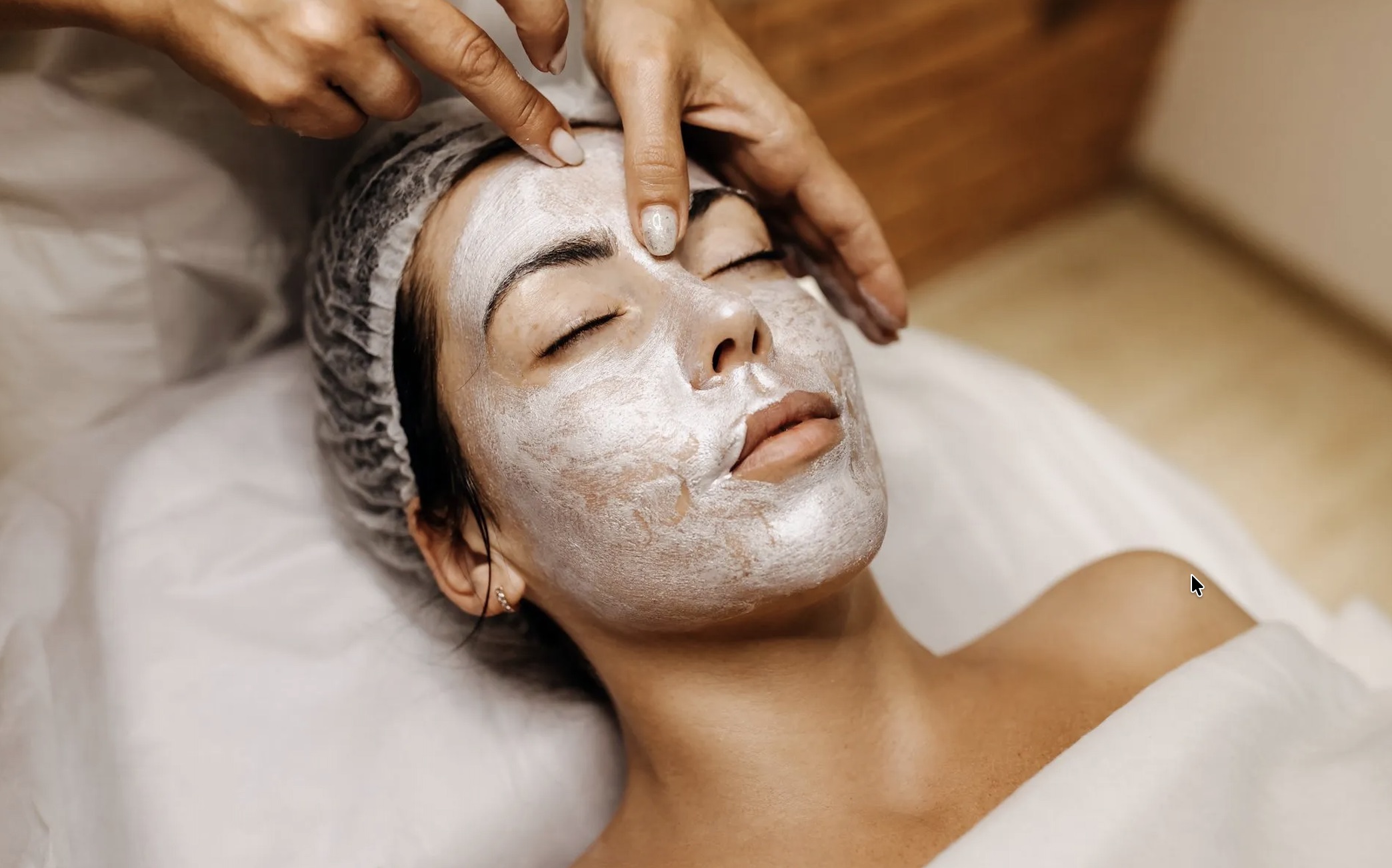 Luxury skincare treatment setup with soft ivory and champagne tones